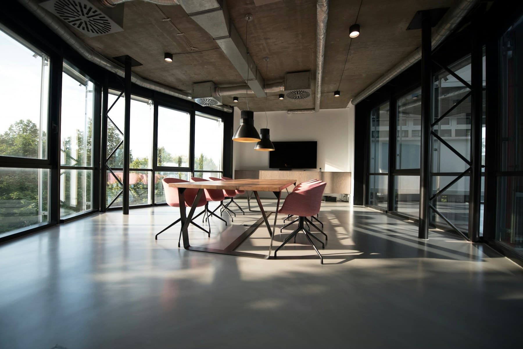A bright office interior with meeting spaces and seating, shown for illustration