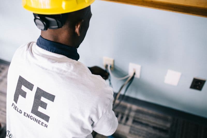 An electrical technician checking wall sockets