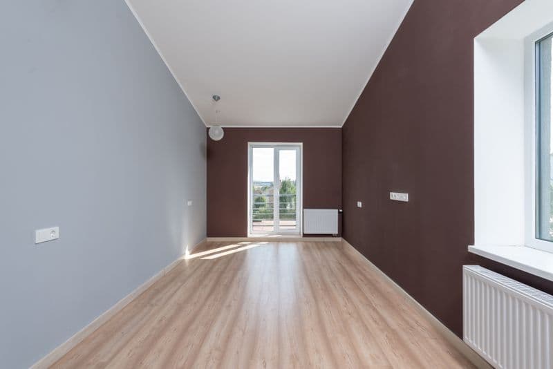 Wood-effect flooring across a bright, empty room