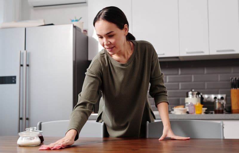 A kitchen worktop being wiped clean